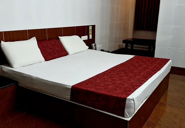 AC Deluxe Room interior at Sathya Garden Resort, comfortable and affordable hotel room in Mettupalayam near Black Thunder